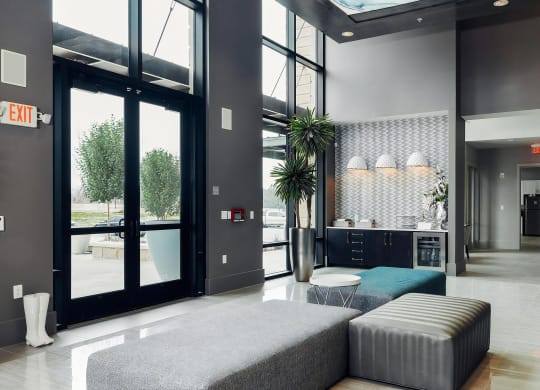 Modern Lobby with Coffee Bar, Patterned Wall Tile, and Lounge Seating