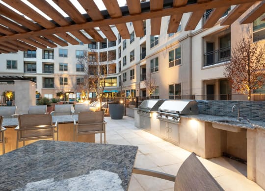 Outdoor Courtyard with Island Bar Seating and Built-In Grilling Stations
