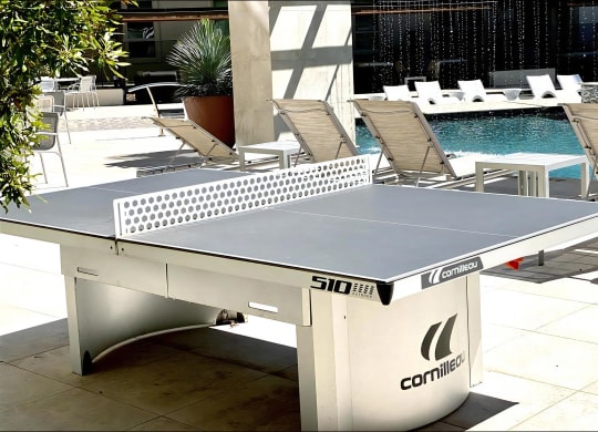 Table Tennis Setup in Courtyard Overlooking Resort-Style Pool