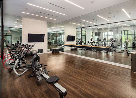 A gym with a variety of exercise equipment.