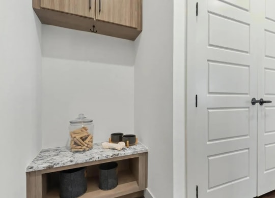 Apartment Entryway Featuring Built-In Cabinets with Storage Hooks
