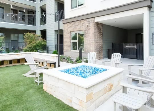 an outdoor patio with a pool and chairs around it