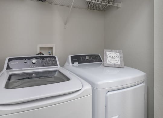 a laundry room with two washes and a dryer