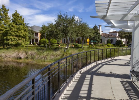a bench on a bridge overlooking a river