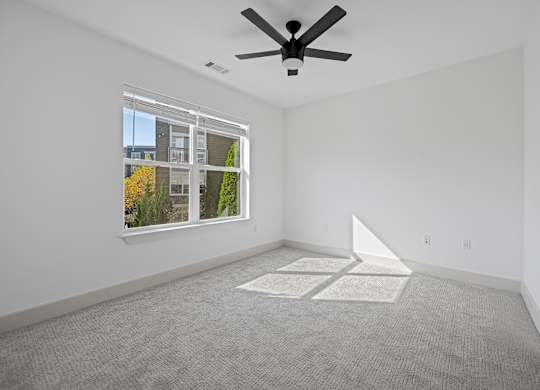 Spacious Bedroom with Carpet and Ceiling Fan and Outdoor Views