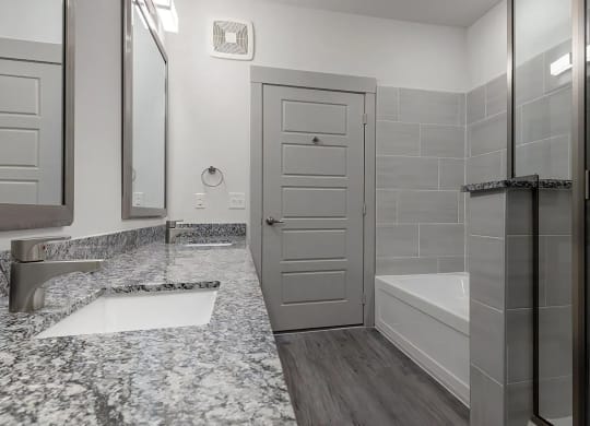 Spa-Inspired Bathroom With Granite Countertops and Dual Bath Options