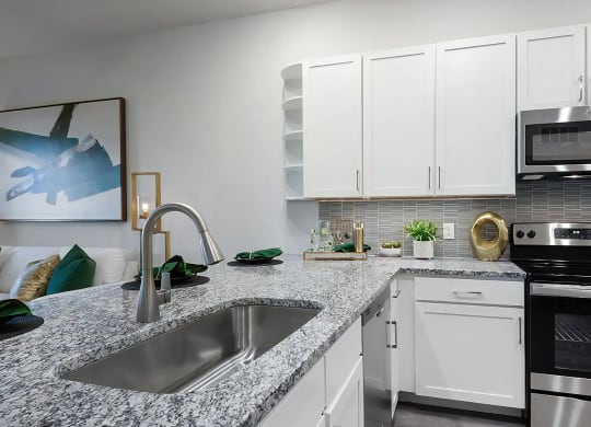 Kitchen with Granite Countertops, Stainless Steel Appliances, and Stylish Backsplash