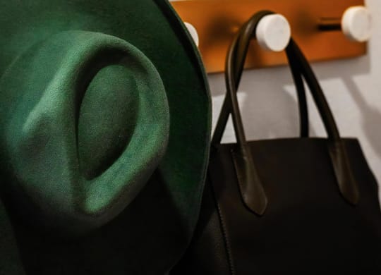 Wall-Mounted Hooks with Stylish Green Hat and Black Tote