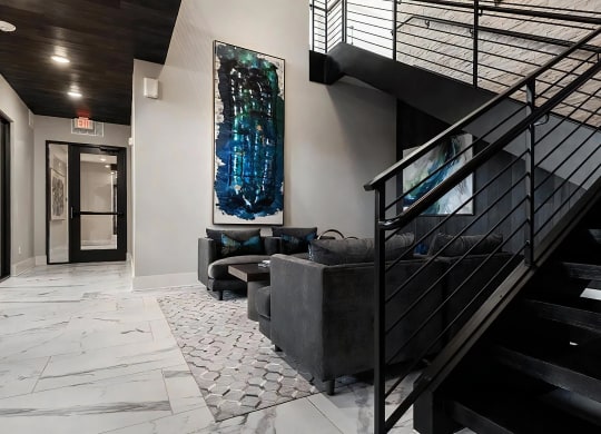Contemporary Lobby with Black Staircase and Cozy Seating Area