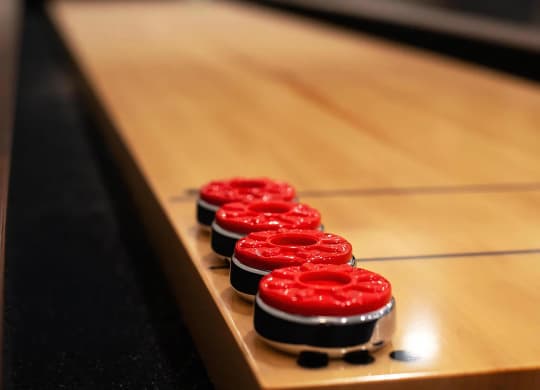 Clubhouse Shuffleboard Table with Bright Red Game Pieces