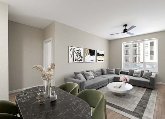 a living room with a gray couch and a dining table