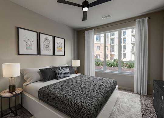 a bedroom with a bed and a large window
