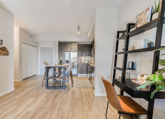 Kitchen Island with Seating and Open Wall Shelving Workspace Nearby