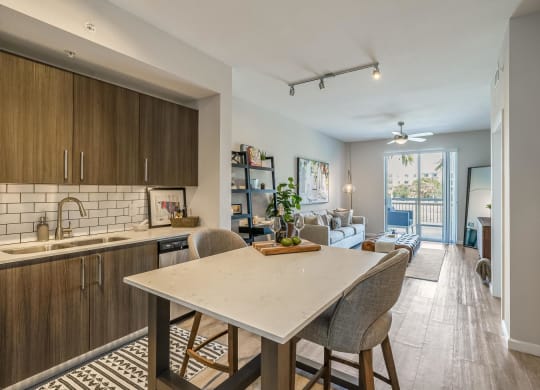 Island with Seating and Full Kitchen Facing Sofa and Sliding Doors