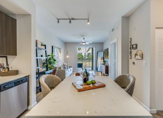 Kitchen Island with Wine Setup and View of Living Room and Balcony