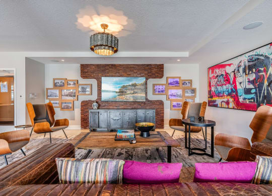 Clubroom Lounge Area with Leather Sofas, Framed Art, and Mounted TV