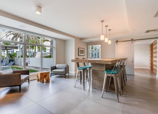 Clubroom with Community Table, Lounge Chairs, and Window Views