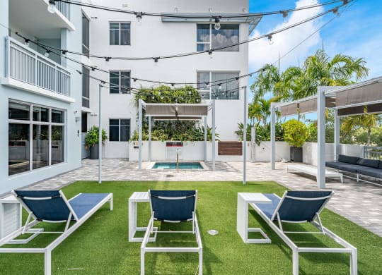 Outdoor Lounge Space With Covered Seating and Lawn Chairs