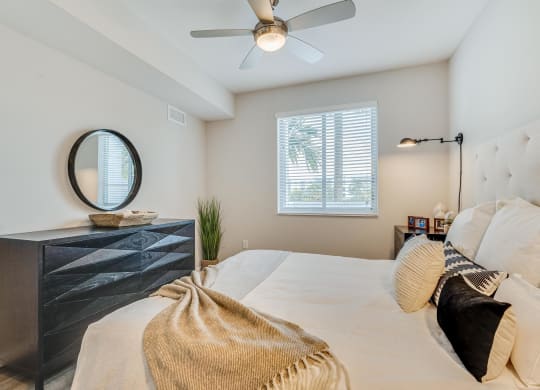 Bedroom with Double Nightstands, Light-Toned Flooring, and Framed Window for Natural Light