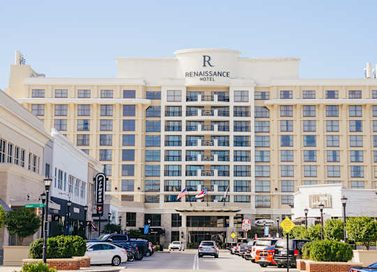 The Renaissance Hotel is a large, white building with a lot of windows.