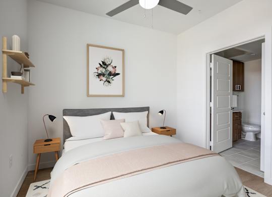 a bedroom with a large bed and a ceiling fan
