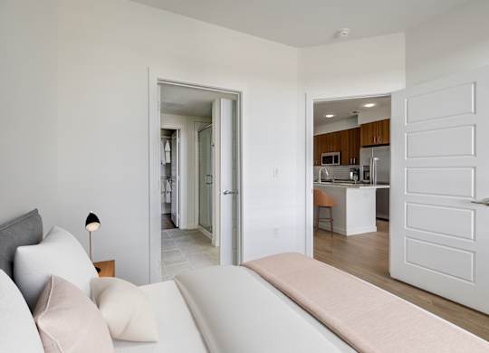 a living room with a couch and a door to a kitchen