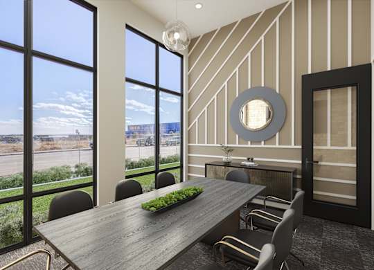 a dining room with a table and chairs and large windows
