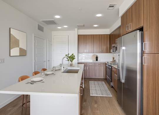 a kitchen with stainless steel appliances and a white counter top
