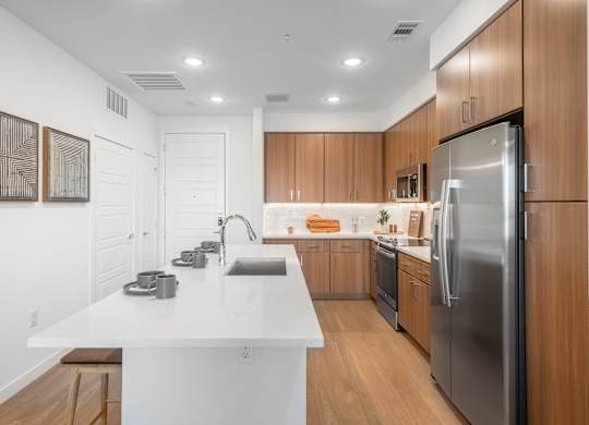 A modern kitchen with wooden cabinets and stainless steel appliances.