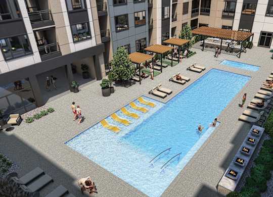 an aerial view of a swimming pool in front of an apartment building
