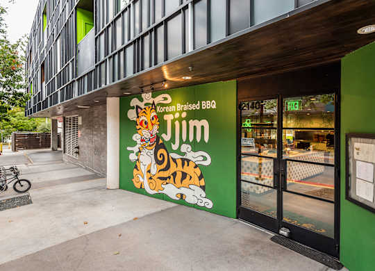 A green building with a tiger on the sign.