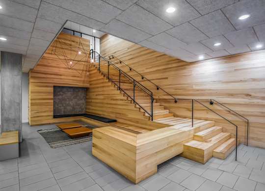 A wooden staircase with a metal railing.