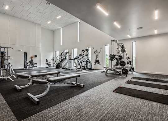 A spacious gym with a variety of equipment including treadmills, weights, and exercise machines.