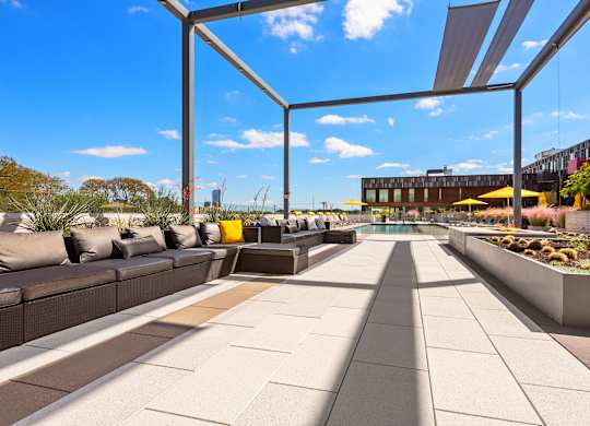 A modern outdoor seating area with a clear blue sky in the background.