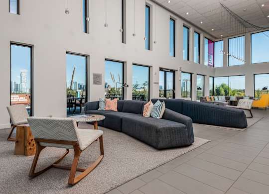 A room with a lot of windows and a view of a construction site outside.