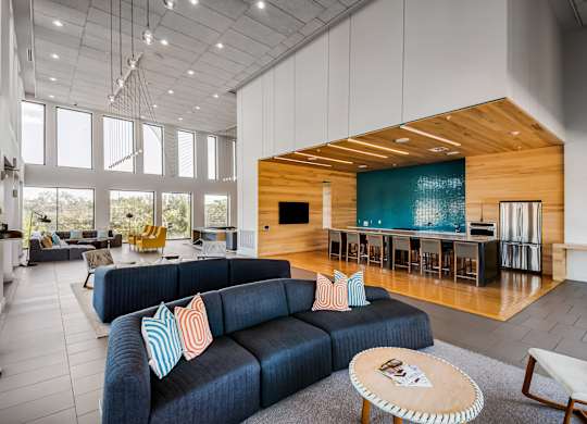 A modern living room with a blue couch and a wooden coffee table.