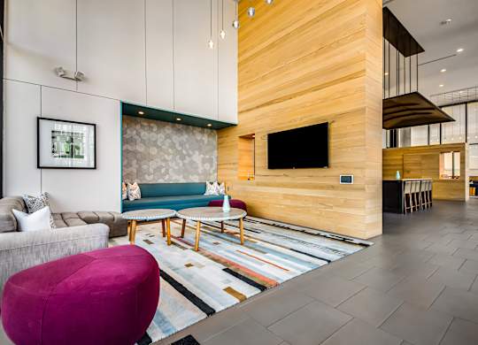 A modern living room with a wooden wall and a flat screen TV.