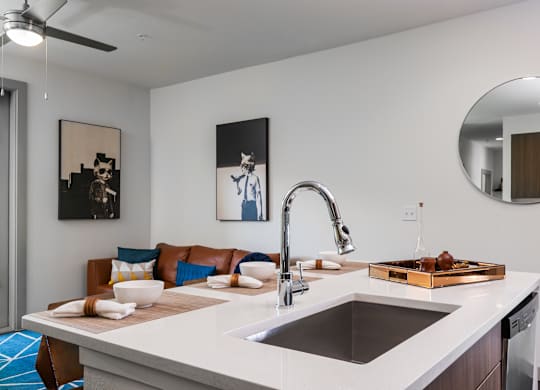A modern kitchen with a white countertop and a brown tray on it.