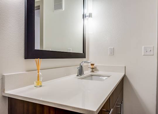 A bathroom sink with a mirror above it.