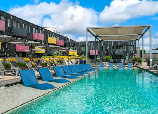 Outdoor Pool Area with Sun Loungers and Shaded Relaxation Zones