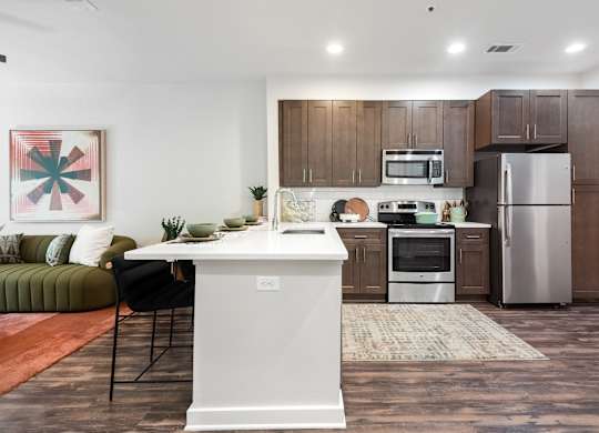Spacious Kitchen with Sleek Cabinetry and Stainless Steel Finishes