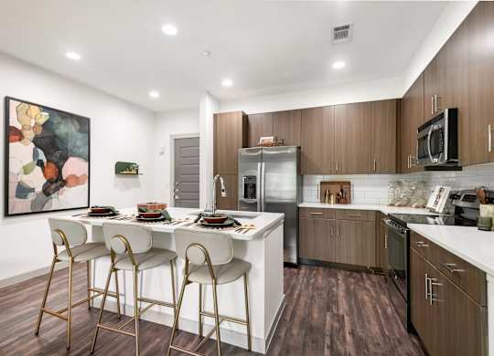 Fully-Equipped Kitchen with Stainless Steel Appliances and Island Seating