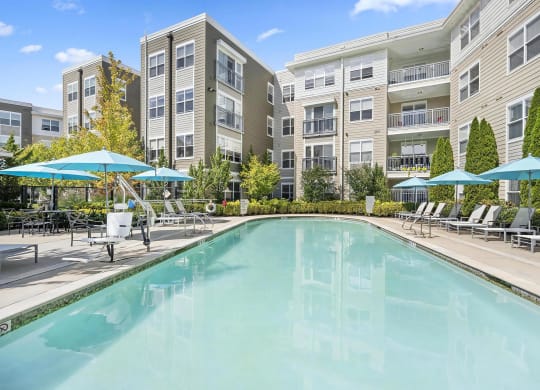 Outdoor Pool Area with Ample Seating and Umbrella-Shaded Loungers