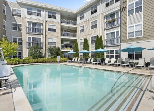 Community Walk-In Pool with Poolside Umbrellas & Chairs