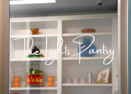 a window with the light it is pantry written on it