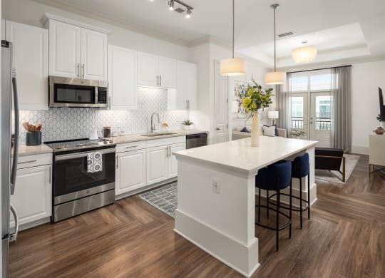 a kitchen with white cabinets and a white counter top