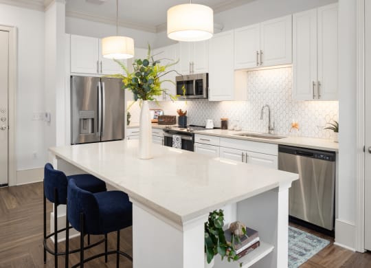 a large white kitchen with a white counter top