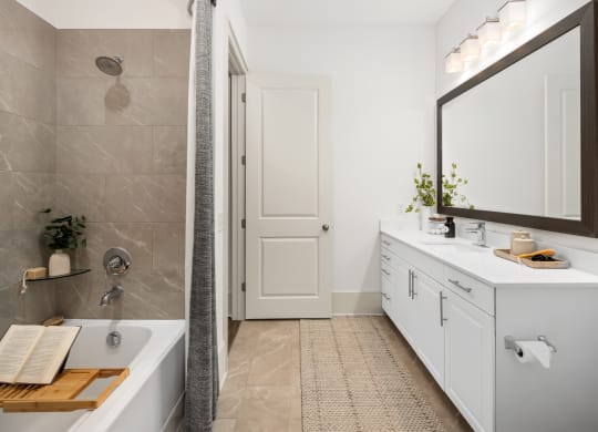 a bathroom with a tub and a sink and a mirror