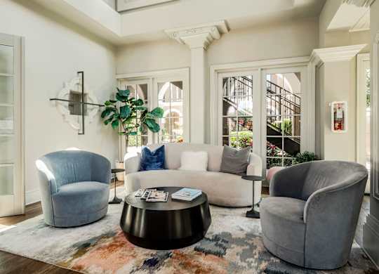 Modern clubhouse lounge with comfortable seating and natural light creating a welcoming atmosphere.