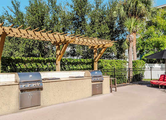 Community grill station with twin stainless grills under pergola